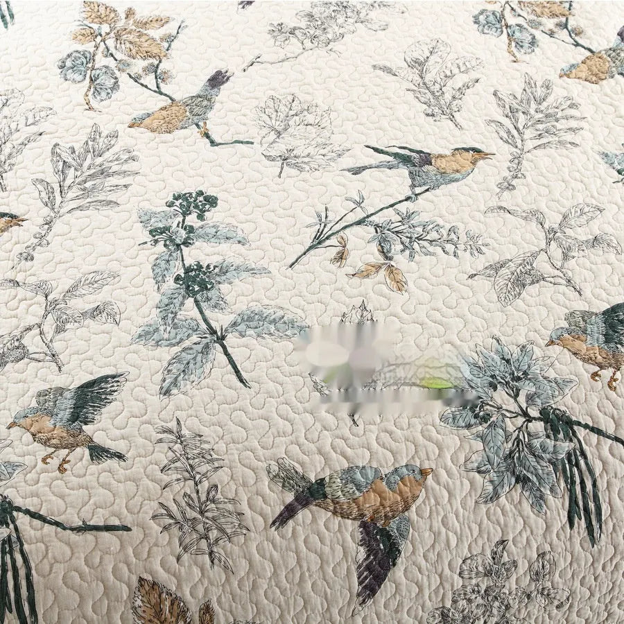 Quilted pure cotton bed cover with printed design, shown on a double bed with two matching pillowcases.