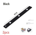 Silver ultra-thin wireless LED strip light with motion sensor attached to a kitchen cabinet door.