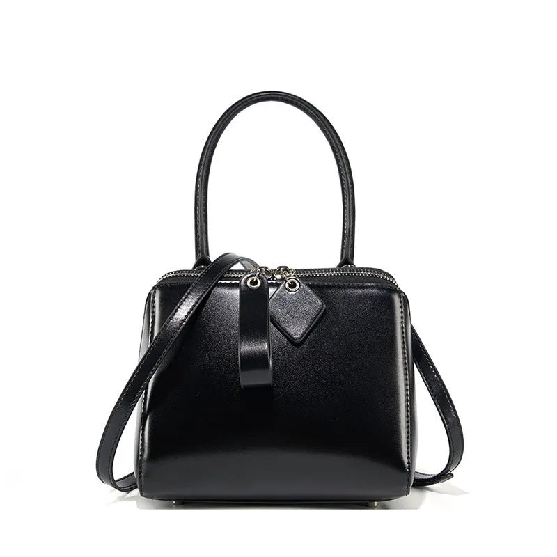Open grain leather handbag with cowhide lining and welt pocket in black, brown or creamy white
