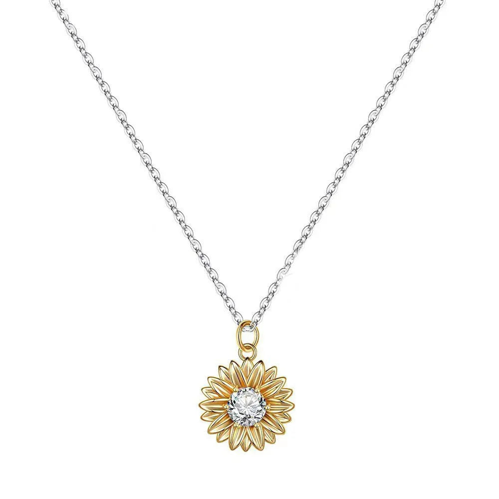 Silver sunflower necklace with geometric pendant and cross chain on a model.