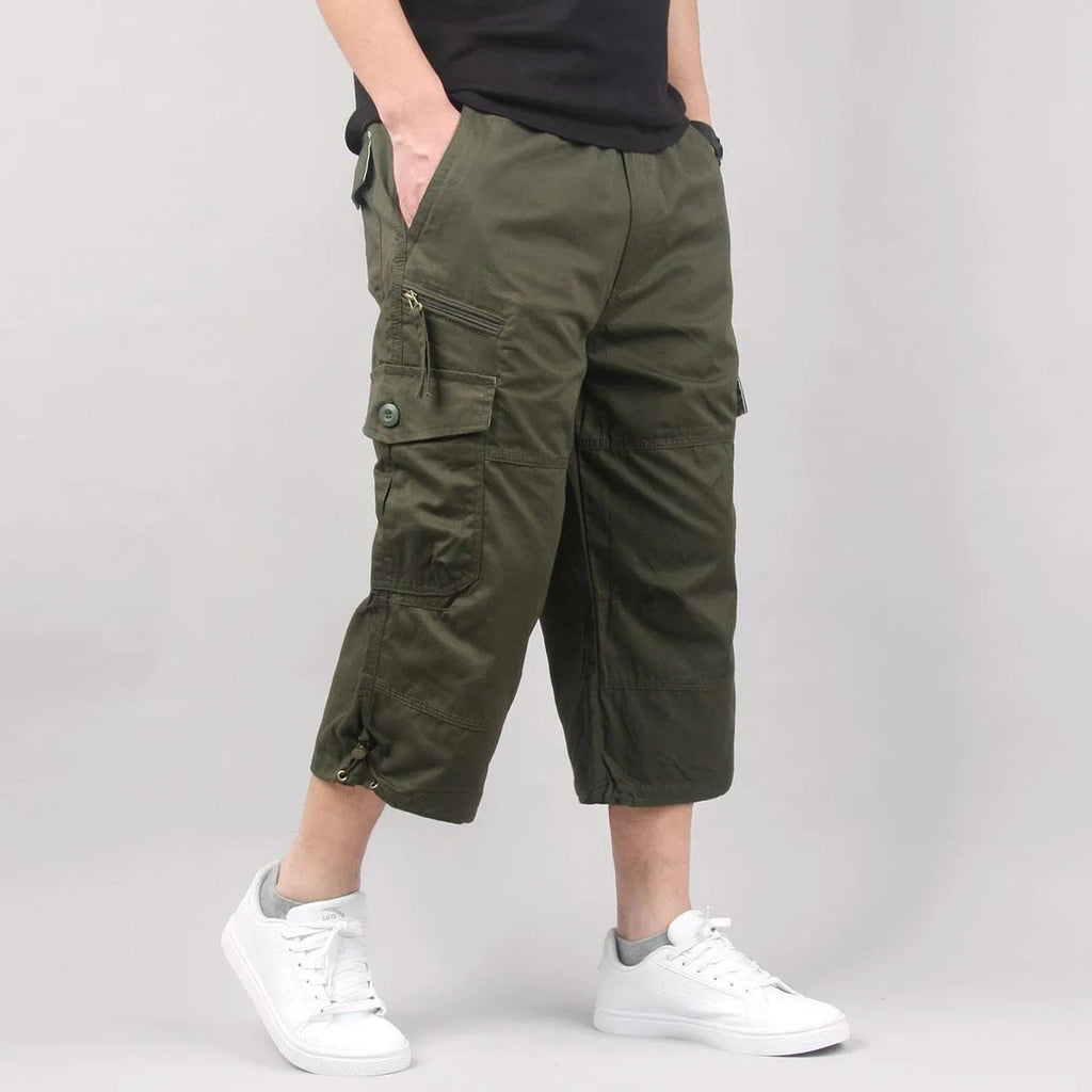 Man modelling loose-fitting khaki cotton cropped casual pants.
