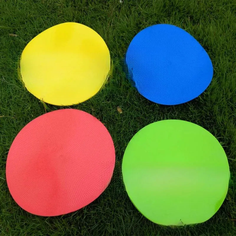 Circular yellow football training marker disc on grass field showing 23cm diameter