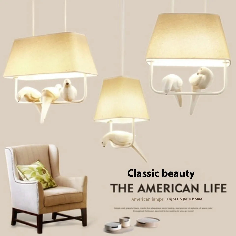 Iron and fabric bird chandelier ceiling lamp with decorative bird silhouette shade.