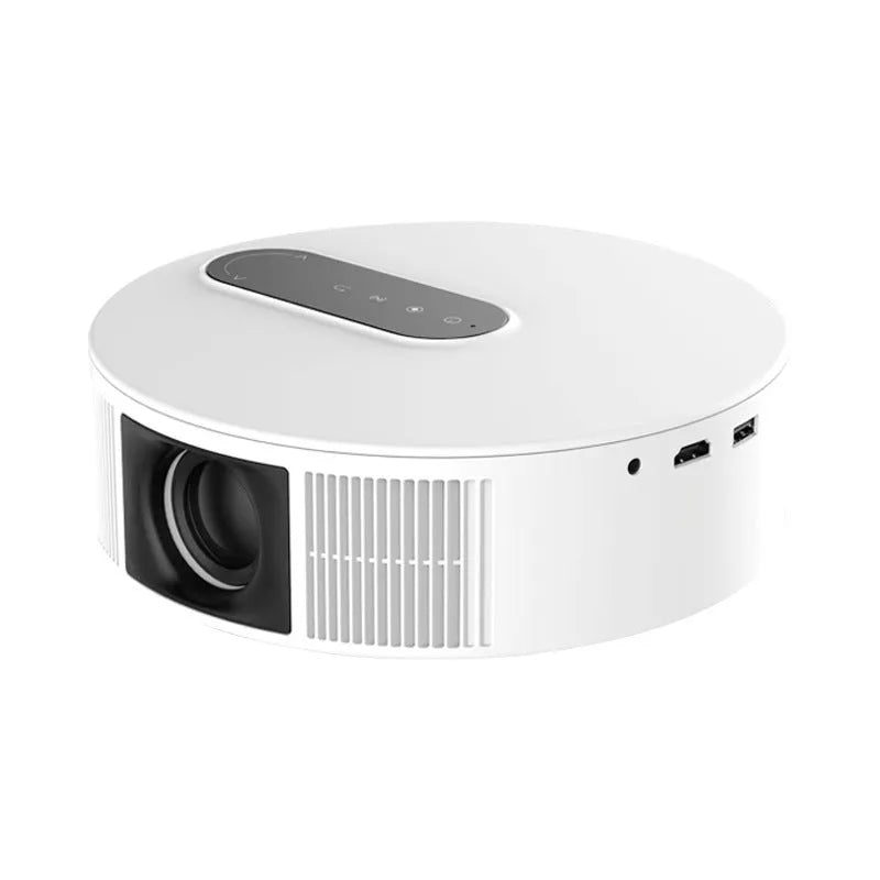 White HD home theatre projector with remote control on a wooden table.