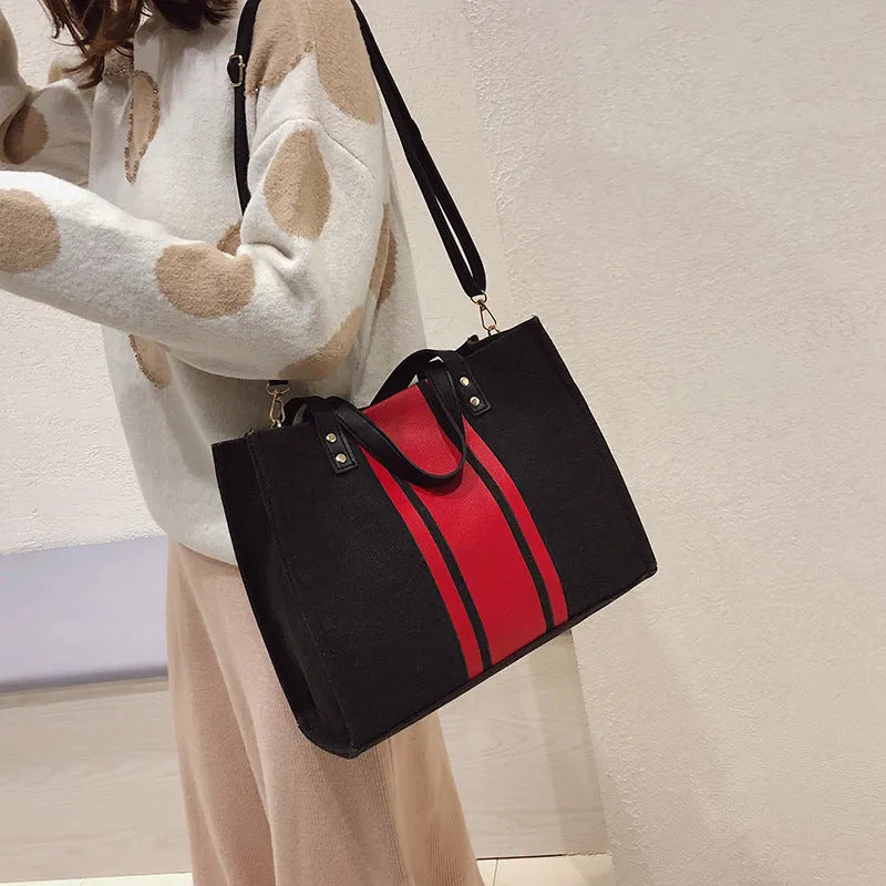 Canvas stripe tote bag in black and white with zipper closure, horizontal square shape, and 120cm shoulder strap