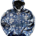Man wearing a loose-fitting blue hooded zip-up coat with digital printing.