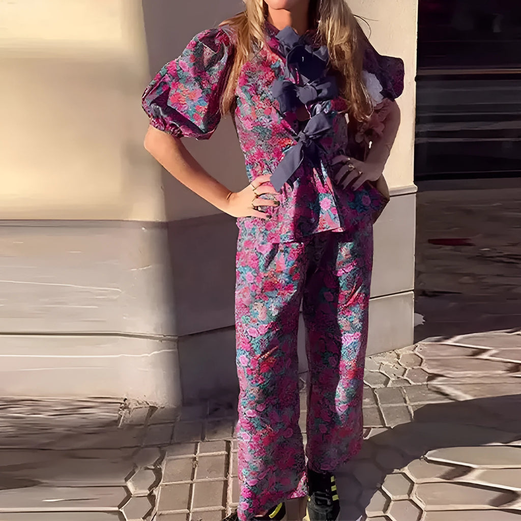 Women's floral print trouser suit with puff sleeves and tie-neck top, coordinating trousers