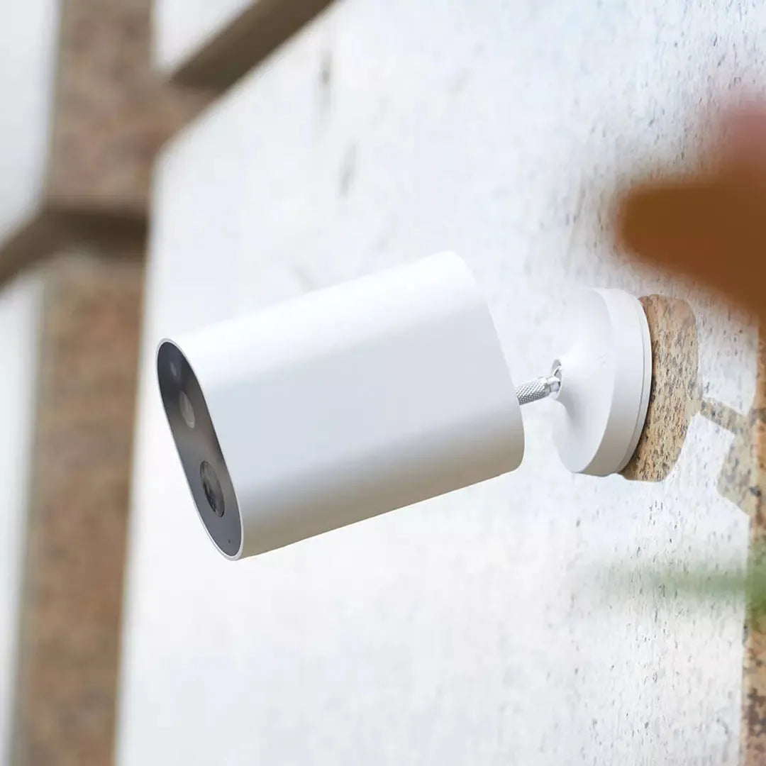 White wireless battery-powered security camera with 5100mAh, 120° view, and voice intercom on wall bracket
