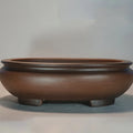 Handmade purple clay classical style desktop flowerpot on a wooden surface