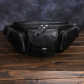 Black slanted chest bag in first layer cowhide with lock detail and polyester lining for daily commute