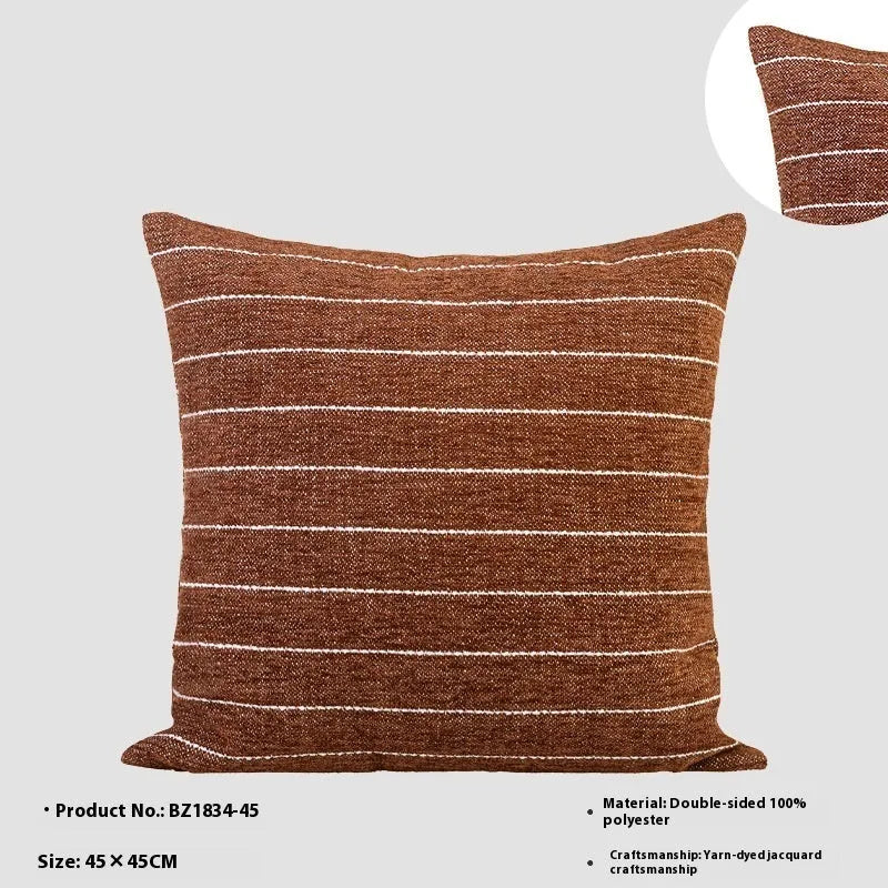 Chinese style square cushion in brown Maillard colour on a sofa.