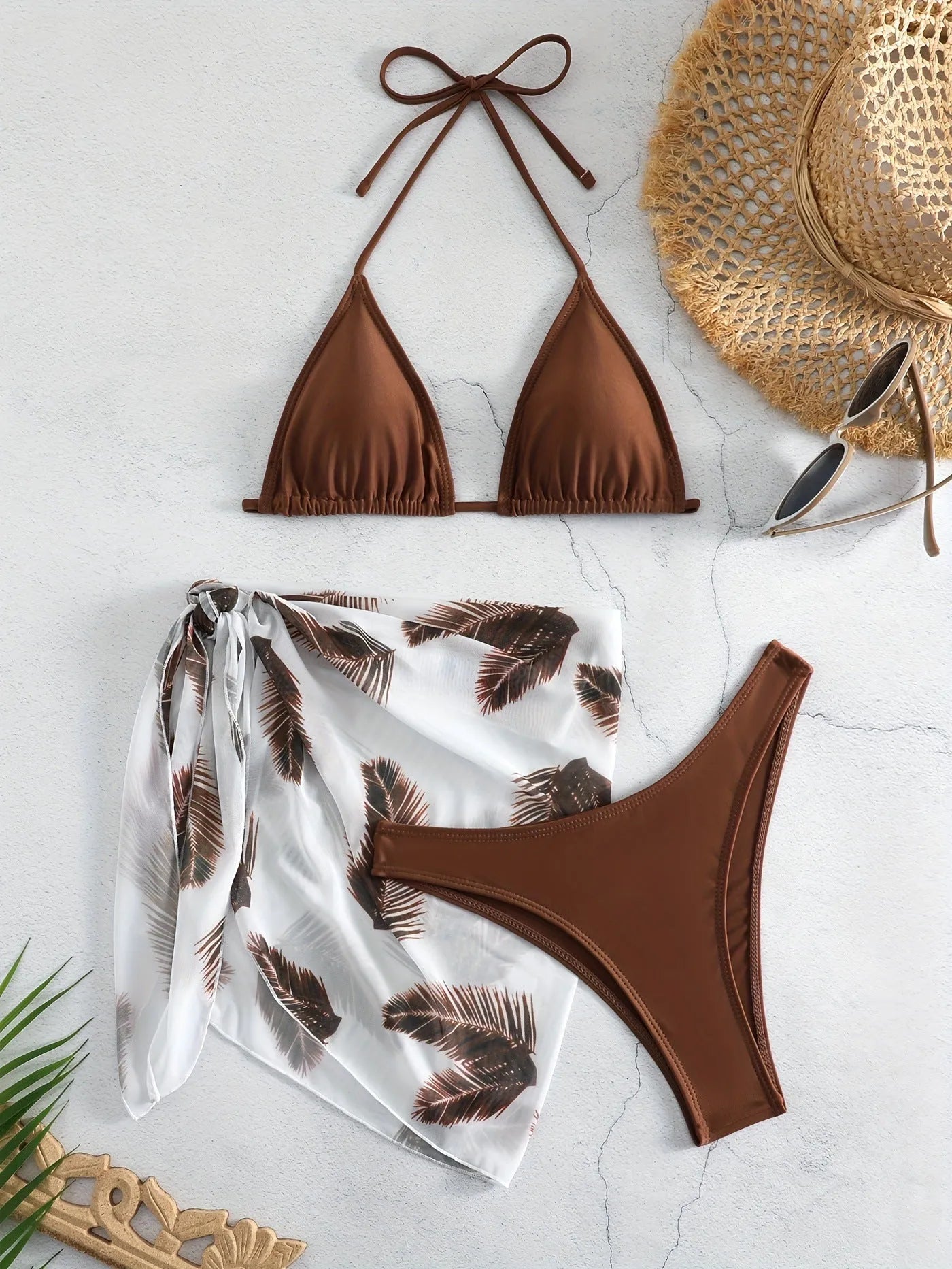Orange three-piece bikini swimsuit set with a printed gauze skirt on a white background