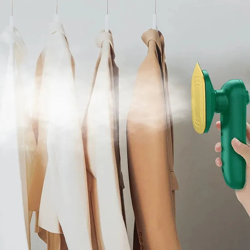 Dark green portable hand-held steam iron with ceramic panel, front view showing sharp corner design and compact size