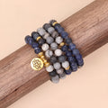 Blue multi-layer bracelet with patterned network stone beads and alloy components.
