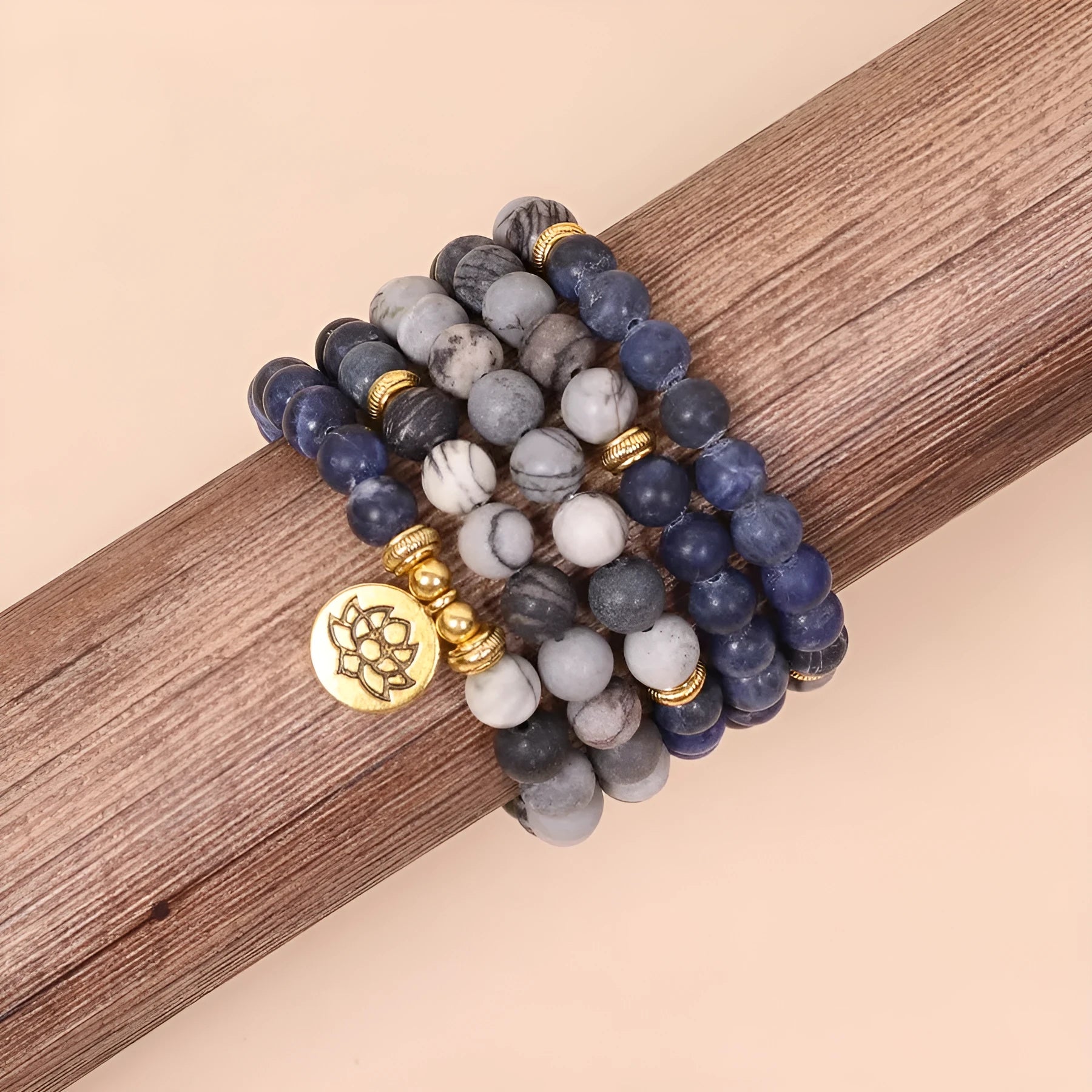 Blue multi-layer bracelet with patterned network stone beads and alloy components.