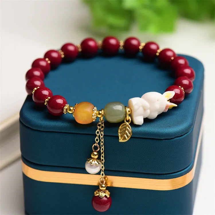 Tian Yu natural cinnabar bracelet with rabbit design in 8mm or 10mm sizes
