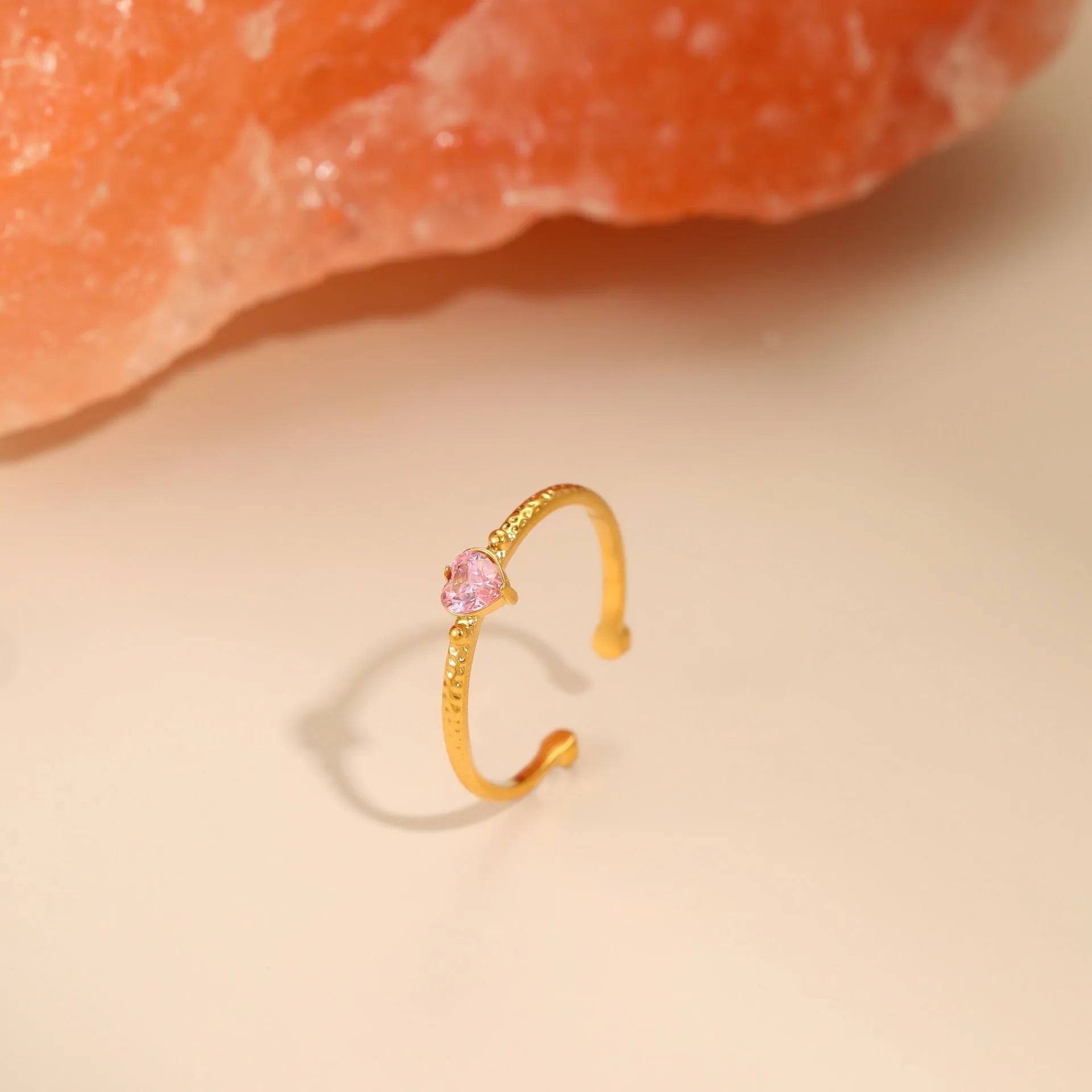 Open-ended stainless steel ring with a geometric design and a heart-shaped zircon inlay.
