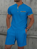 Man wearing a grey waffle texture short sleeve zip-up jacket and matching shorts from the suit set.