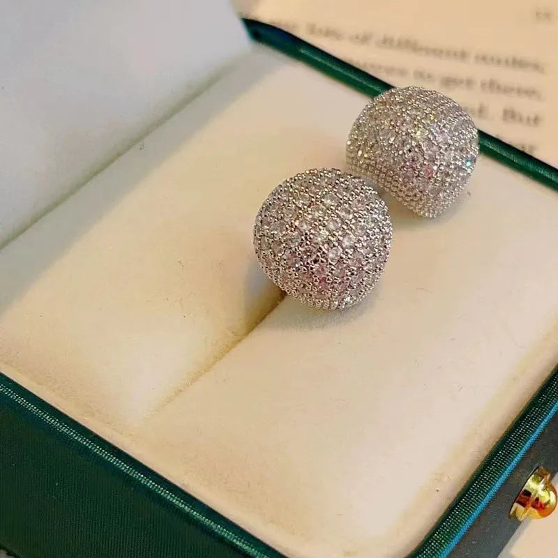 Geometric drop-shaped earrings with full diamond detailing, spherical elements, and little golden beans motif in gold or white colour
