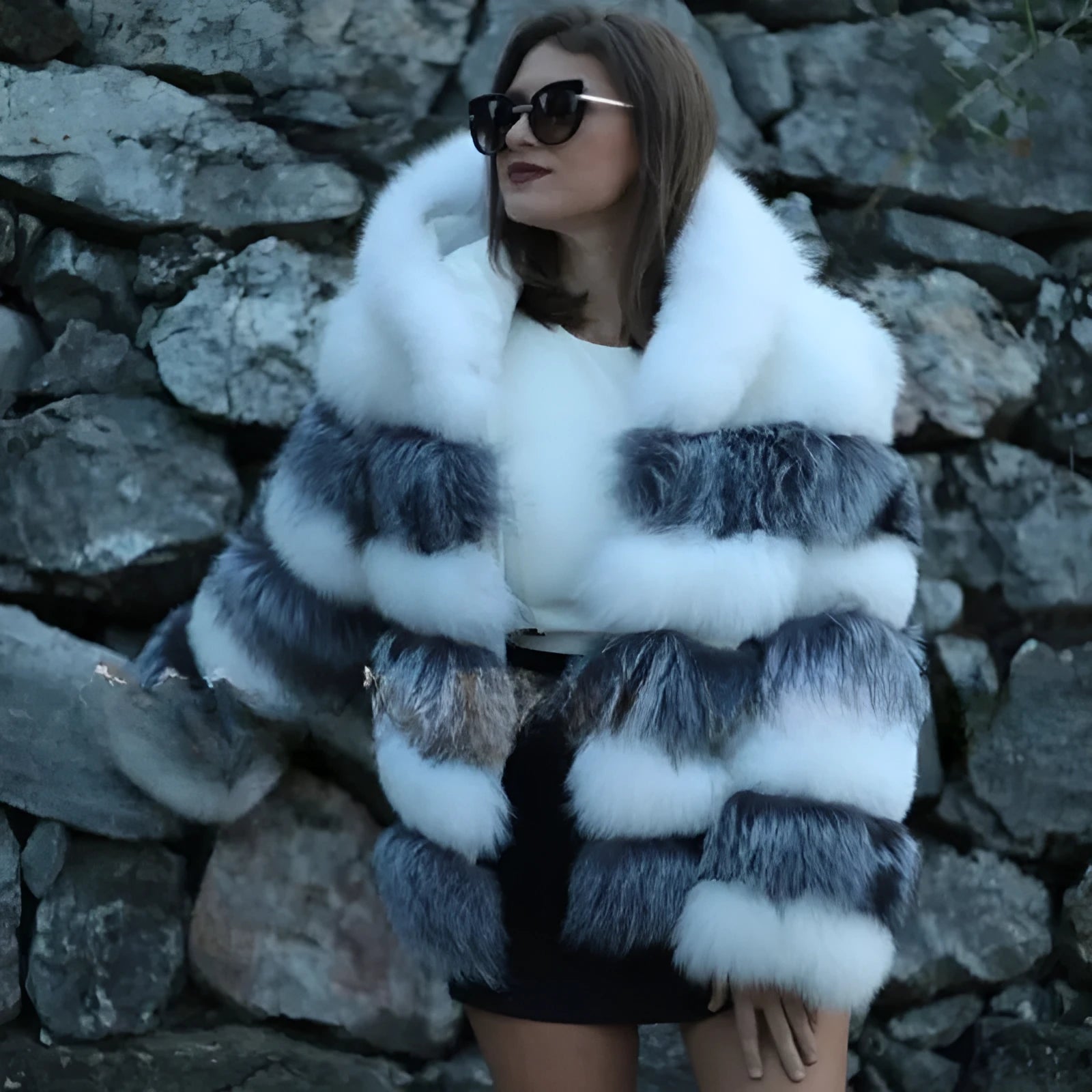 Women's loose fit artificial fur hooded coat in white silver fox colour on a hanger.