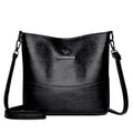Women's soft leather bucket shoulder bag in black with sewing line detailing and mobile phone pocket