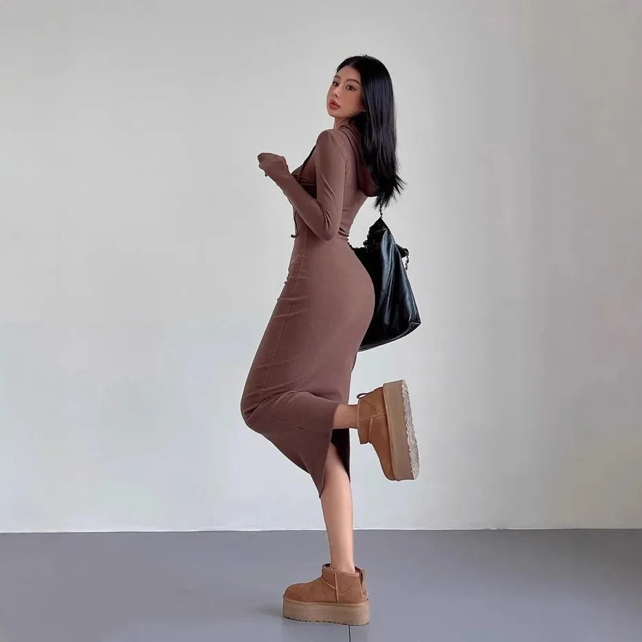 Women's light gray hooded sheath dress with long sleeves and a high waist on a hanger