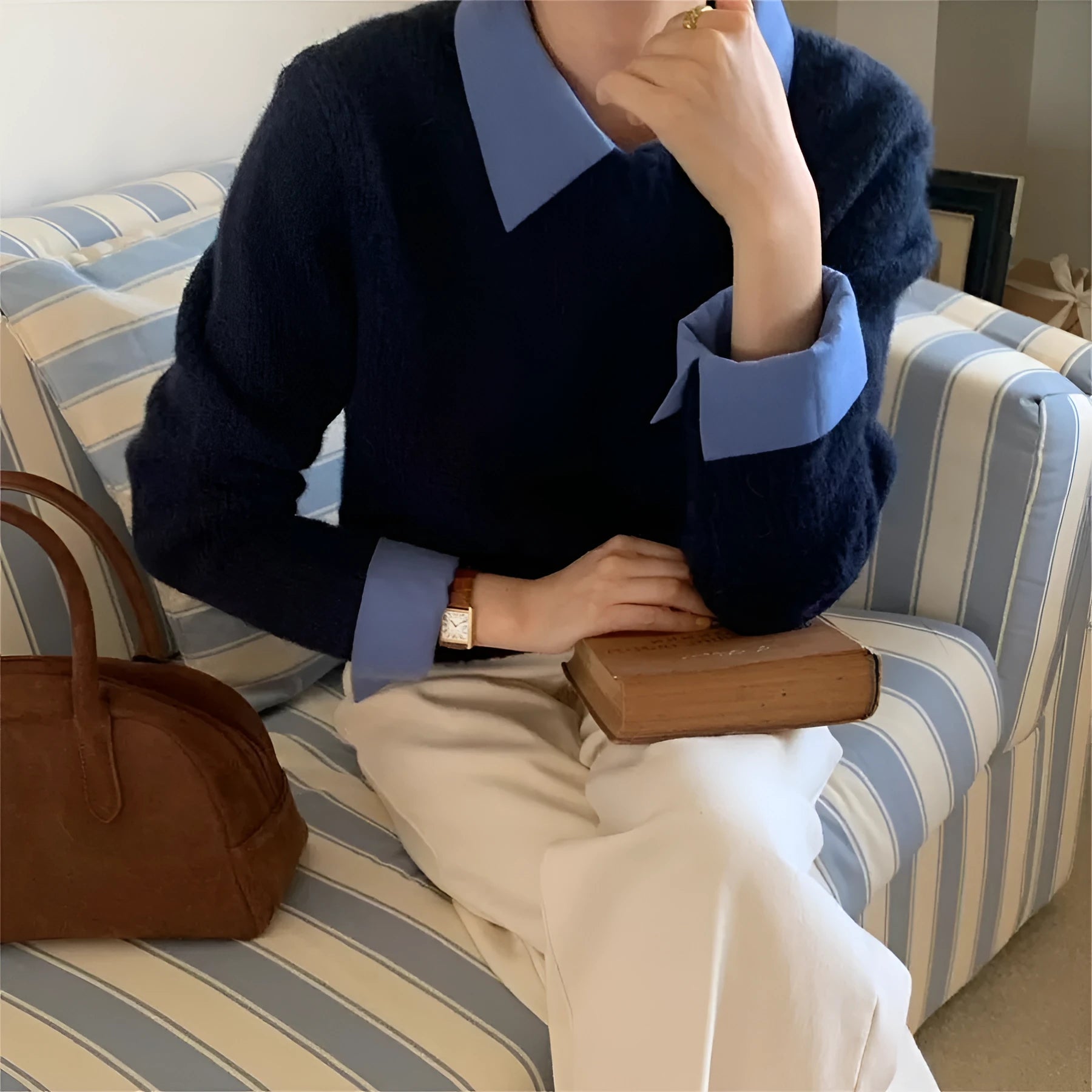 Women's loose-fit knit top with contrast lapels in navy blue, showing front design.