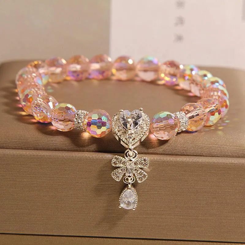 White crystal women's bracelet with butterfly and water drop charms on a metal chain, Japanese Korean style snowflake element.