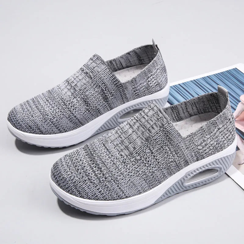 Women's casual running shoes with mesh and PU upper in beige, showing round toe and mid-heel design.