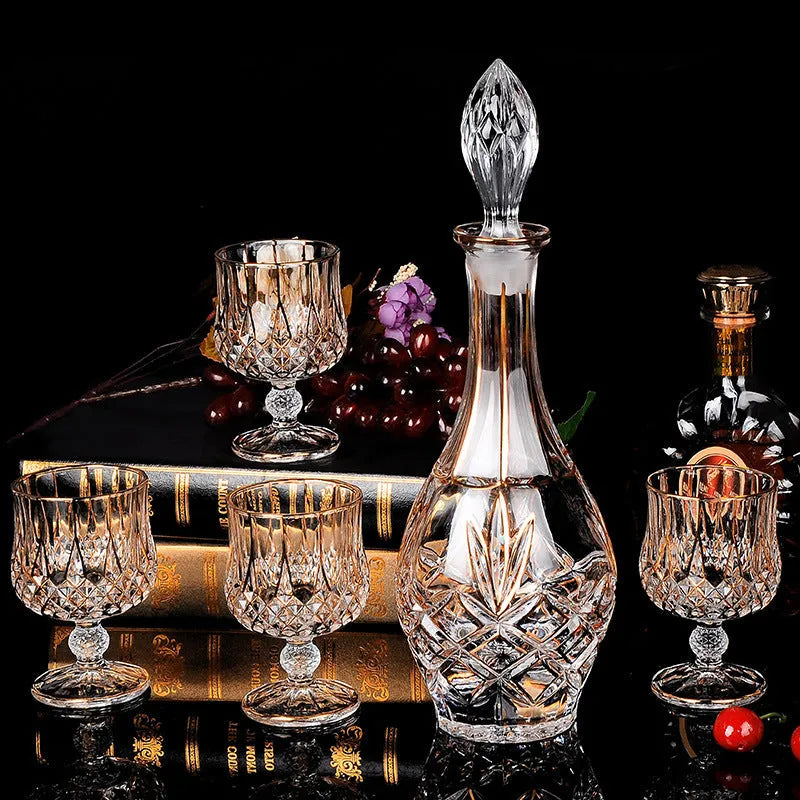 Six yellow crystal glass whiskey glasses with golden accents on a table