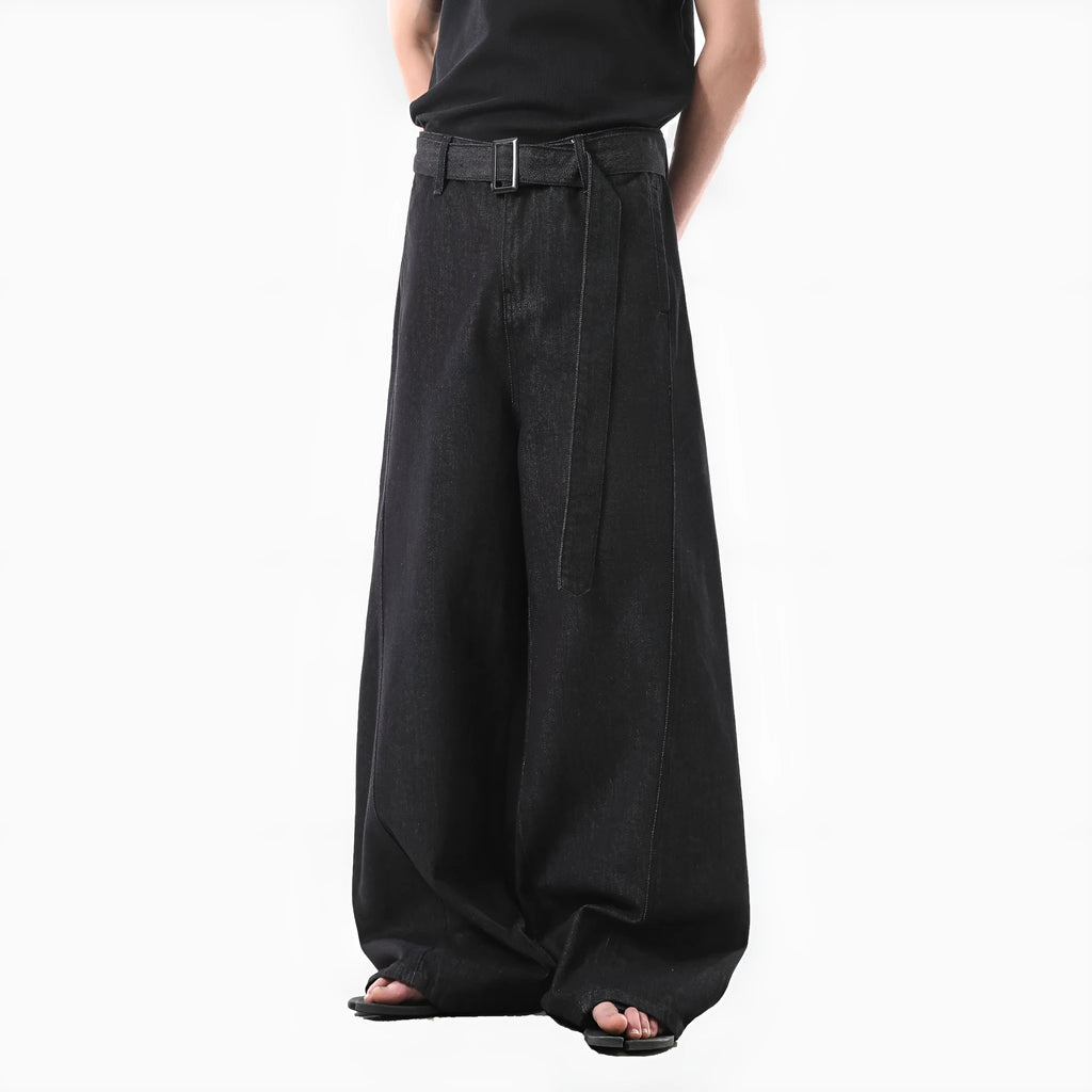 Black high waist straight leg jeans with gold details on a model.