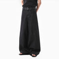Black high waist straight leg jeans with gold details on a model.