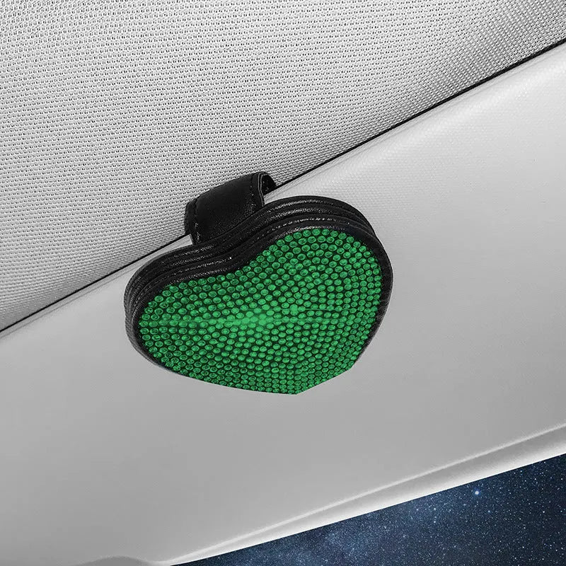 A black PU leather magnetic storage clip with a diamond pattern on a car sun visor, holding a pair of sunglasses.