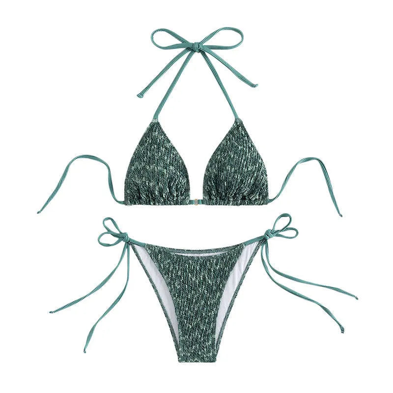 Green backless women's bikini set with halter neck strap and matching shorts.