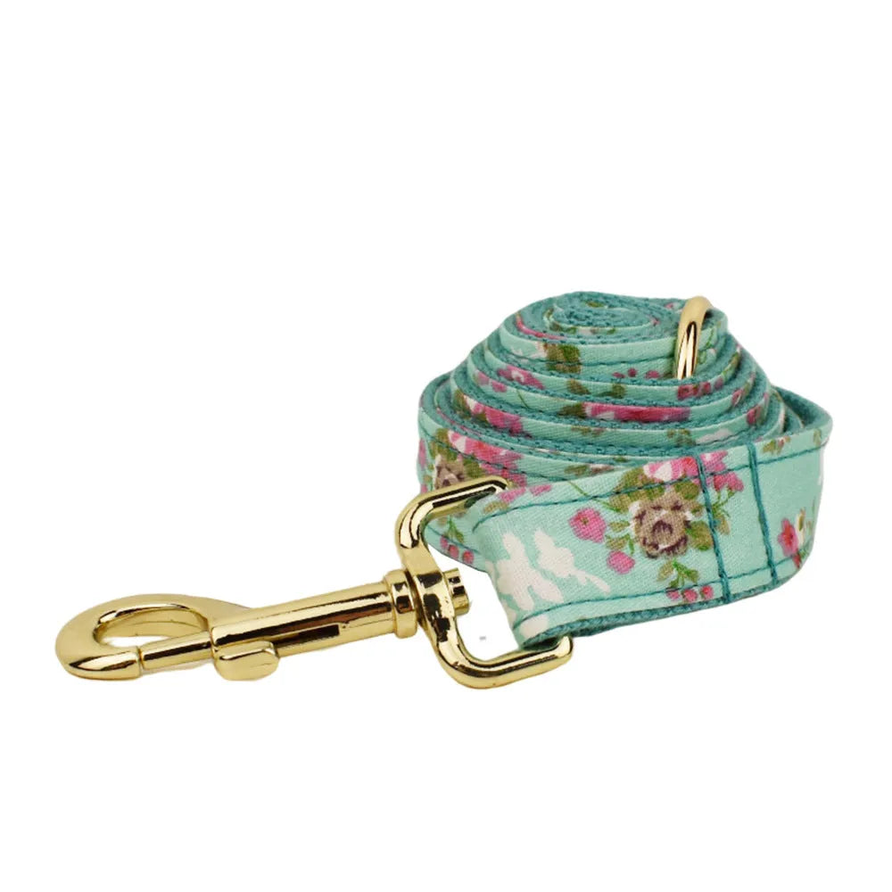 Fabric dog collar set with rose pattern detachable bow, matching leash, and optional vest in green background