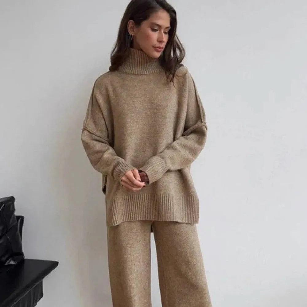 Dark grey women's knitted side-slit top and matching trousers set on a hanger