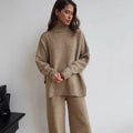 Dark grey women's knitted side-slit top and matching trousers set on a hanger