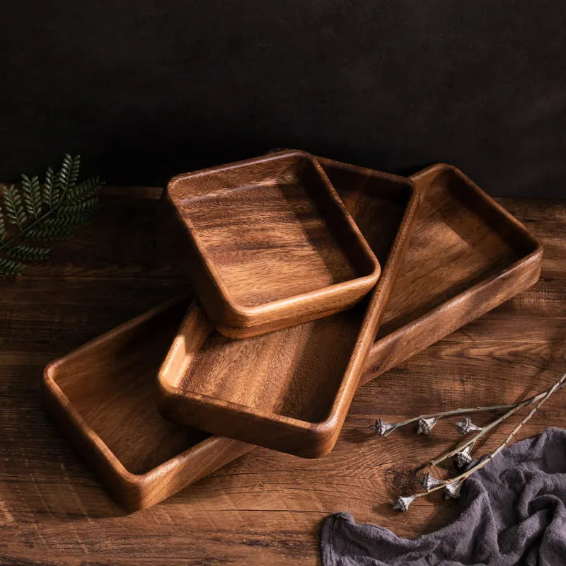 Walnut wooden fruit plate tray in rectangular size on a table surface.