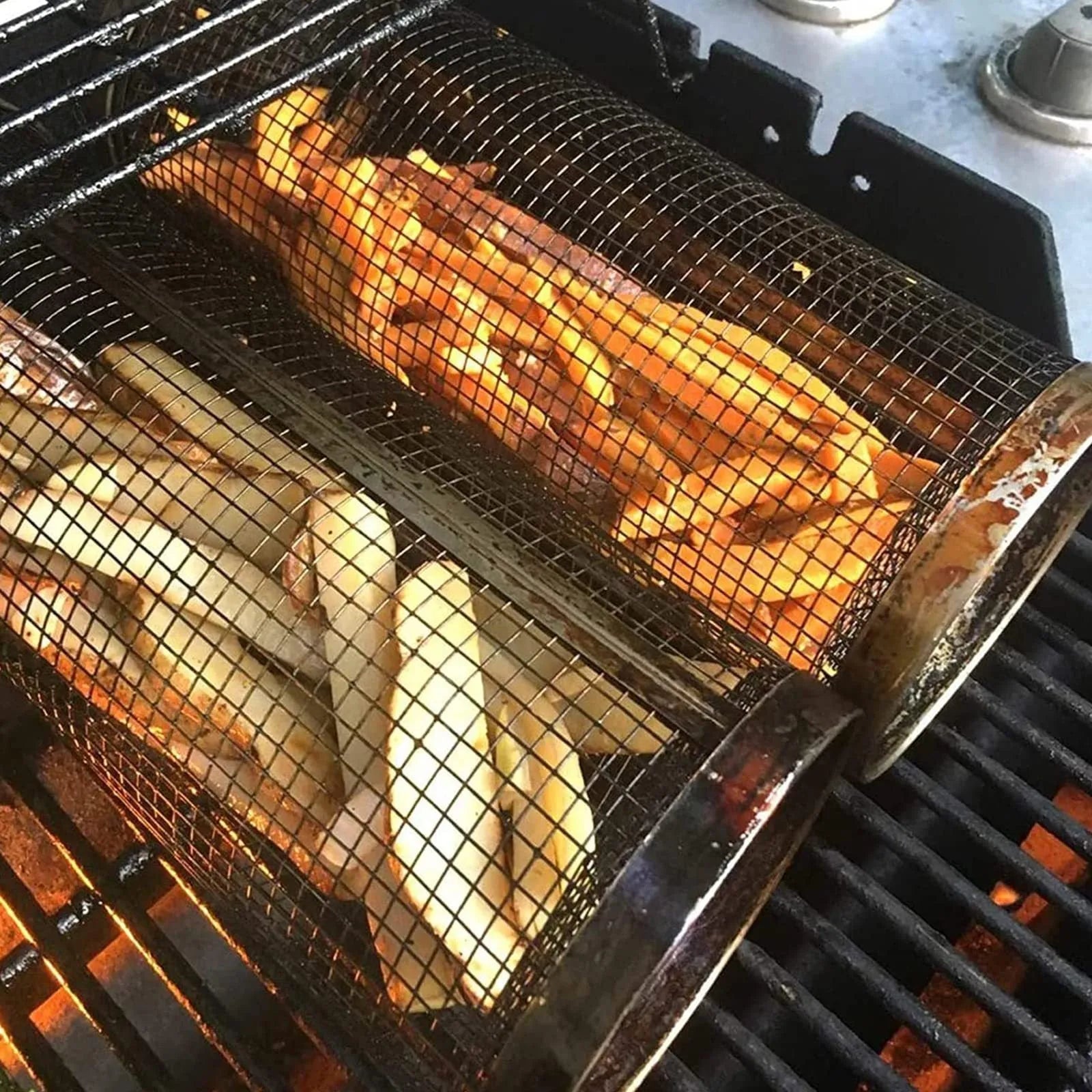 Round stainless steel rolling barbecue grilling basket with mesh sides and a hook, shown with assorted vegetables inside.