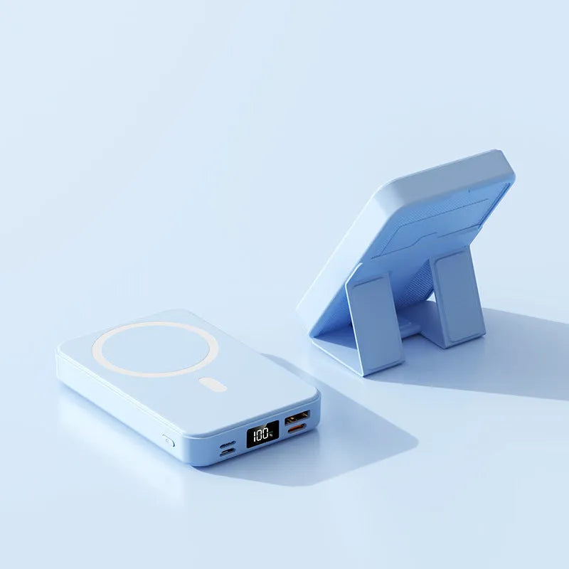Magnetic wireless power bank with bracket in white, showing 10000mAh capacity and USB port, on a desk