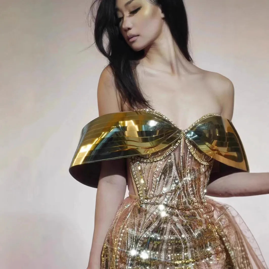 Gold strapless sequined dress with tulle skirt split, showing front and back views