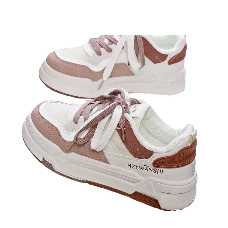 Children's beige platform trainers with cross-strap design over laces and a thick rubber sole.