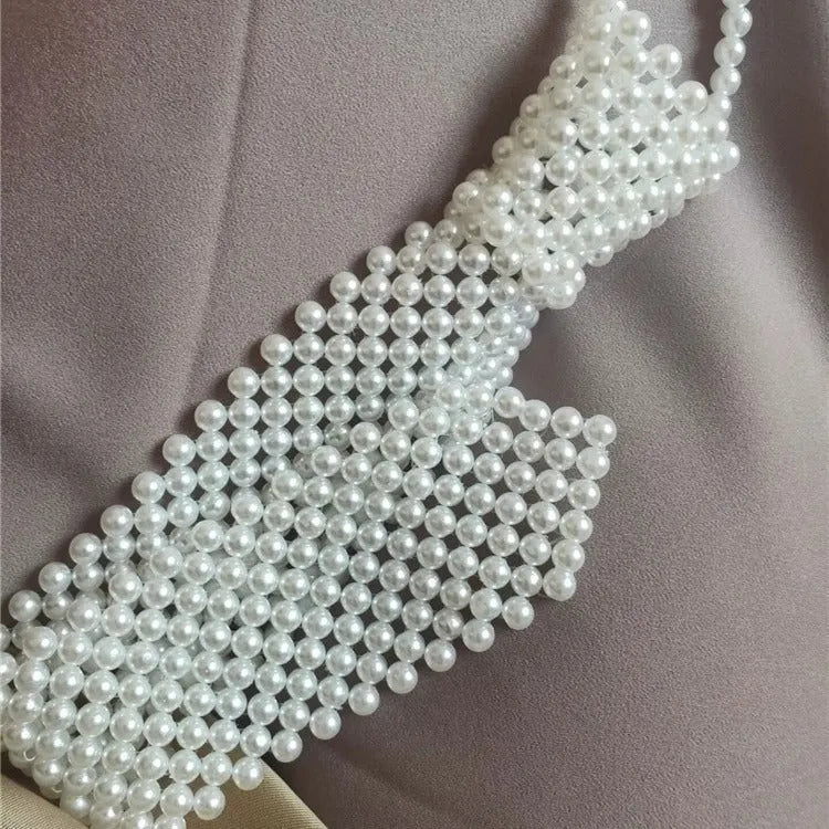 Women's pearl tie body chain with hollow out design and adjustable alloy closure in black or white colour