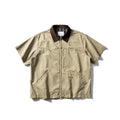 A khaki washed cotton overalls shirt with short sleeves and a loose cardigan style, laid flat.