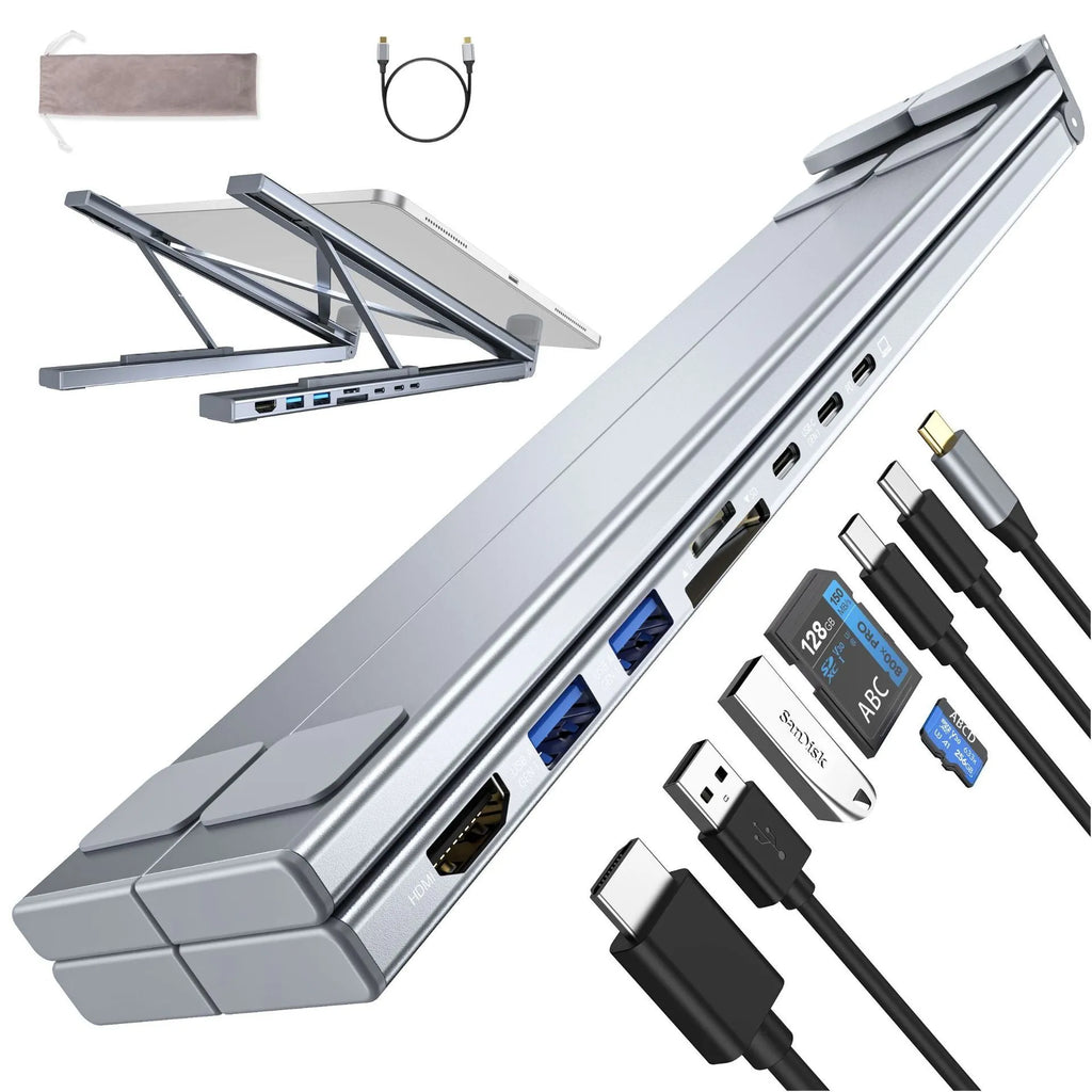 Silver aluminium folding laptop stand with integrated multi-port docking hub on a desk.