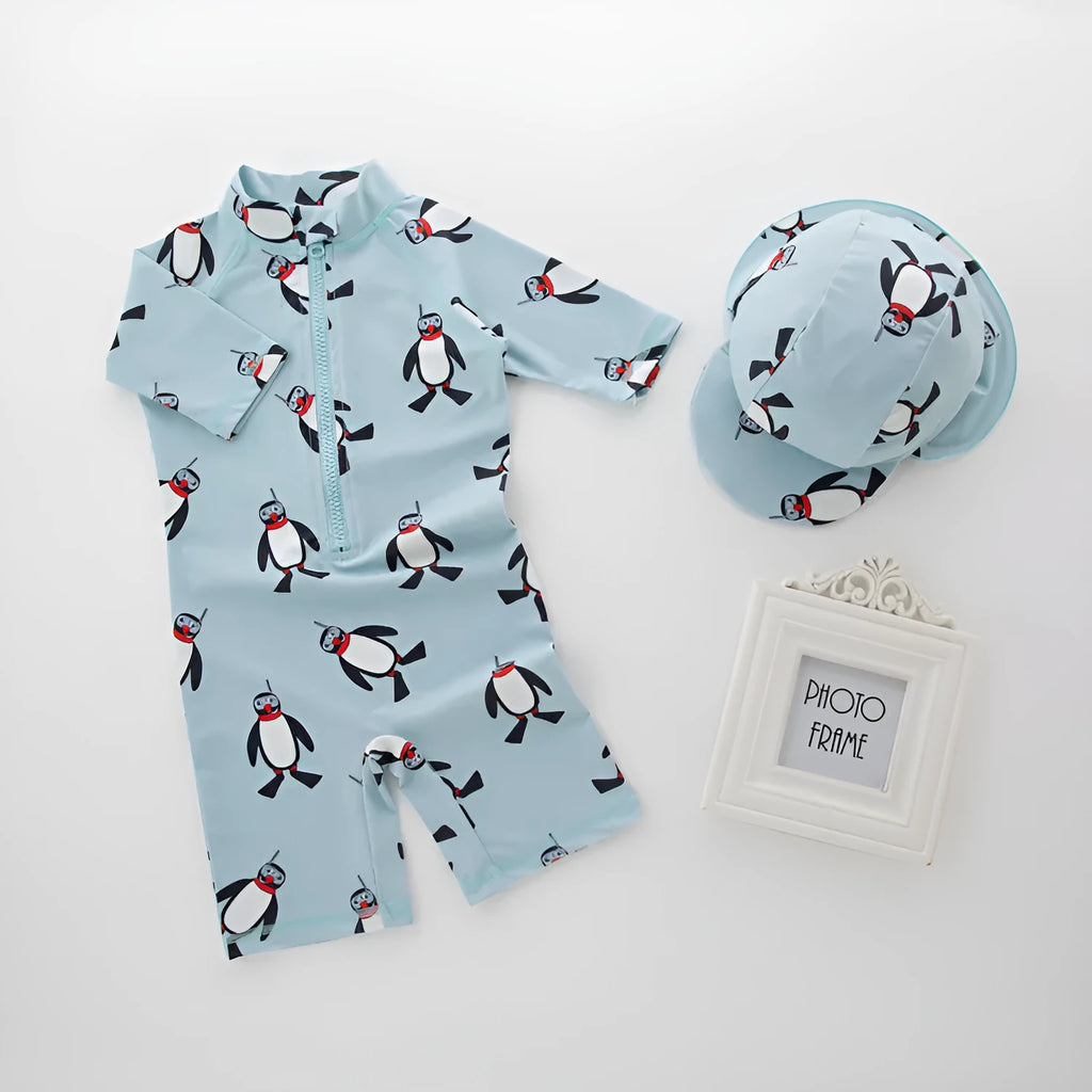 Boys' penguin print two-piece swim set with long sleeve rash guard top and matching swimming cap