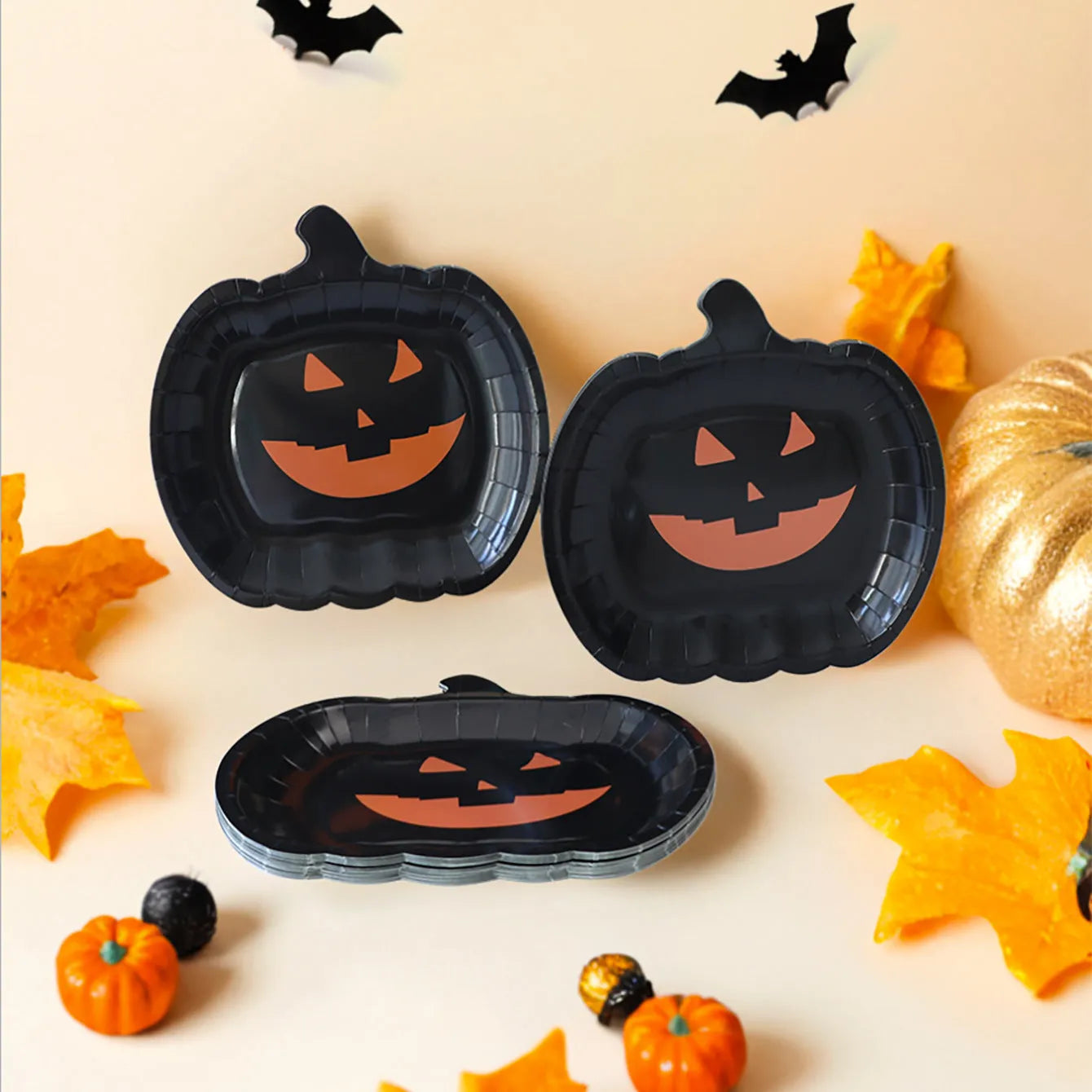 Black Halloween disposable paper plates with pumpkin designs, 9-inch diameter