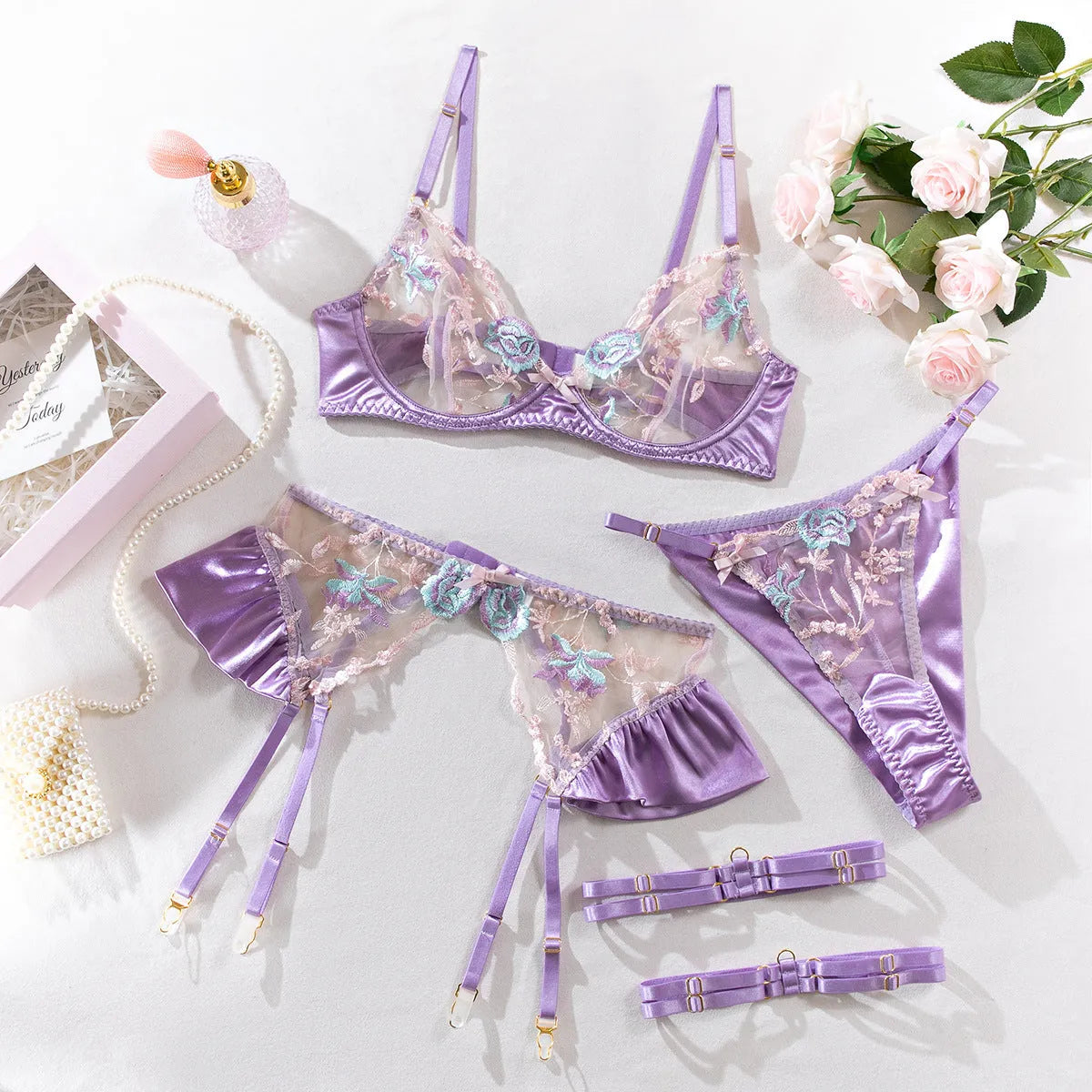 Light purple satin four-piece lingerie set showing all components with champagne colour option