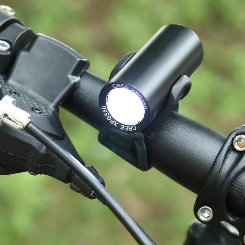 Black USB rechargeable bicycle front light with 350 lumen output mounted on handlebars.