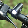 Black USB rechargeable bicycle front light with 350 lumen output mounted on handlebars.